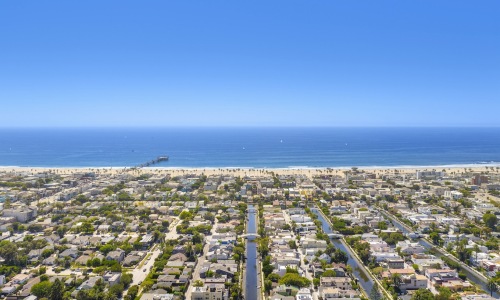 Love where you live aerial view of a city with a beach and body of water