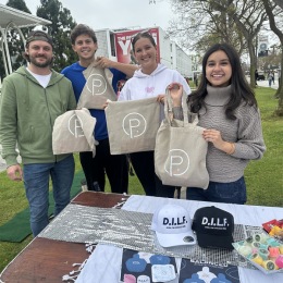 people holding up Porter Mar Vista merch outside