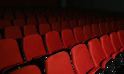 Close to the center of everything a row of red chairs